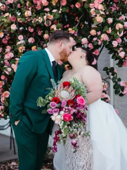 Molly and Kevin Share a Kiss in Modern and Vibrant Wedding with Unique Florals at Holbrooke Hotel