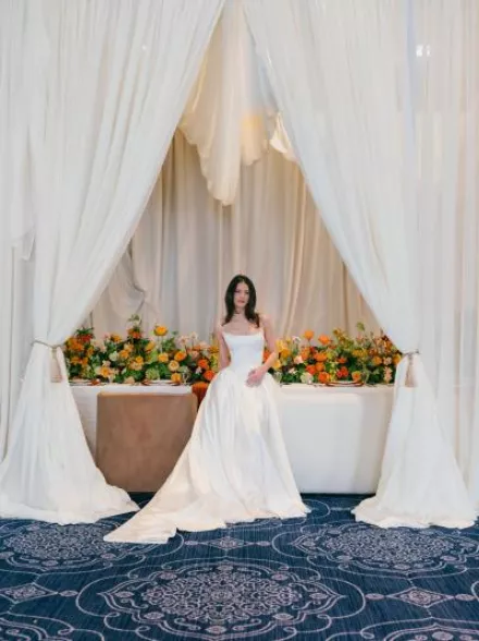 Model poses in front of boldly styled reception table at The Sentinel