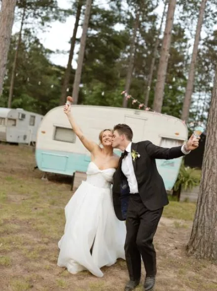 Molly and Ralph pose with their ice cream cones on their wedding day at Camp Elsewhere
