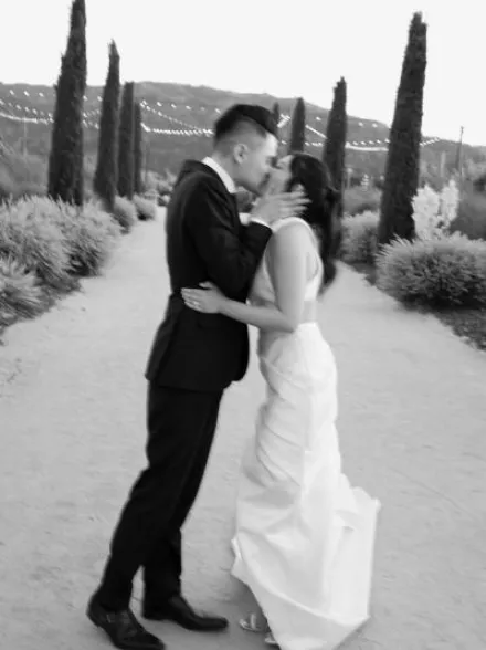Stephanie and David Share a Kiss Outdoors at Wedding at Tre Posti
