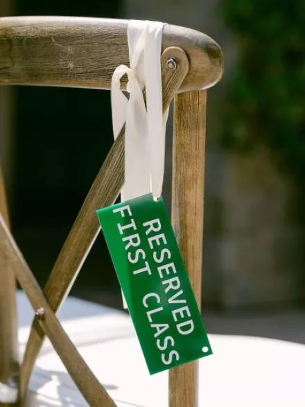 Aviation themed escort card hanging on chair