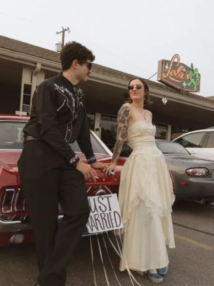 Bride and Groom pose outside of their restaurant wedding day 