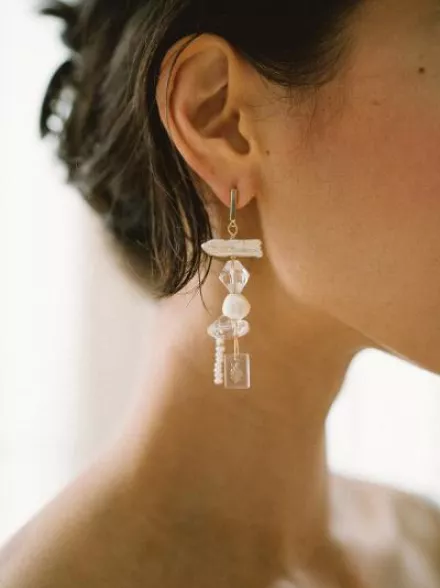 Close-up of a handcrafted glass earring from Rileyhaus featuring a delicate, artisanal design