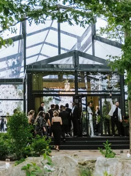 Guests file in to a greenhouse-style venue