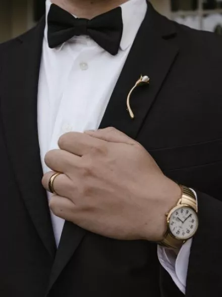Close up of brooch on lapel of tuxedo